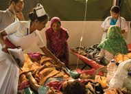 In Bangladesh, a nurse uses simple rehydration therapy to treat a patient with cholera.