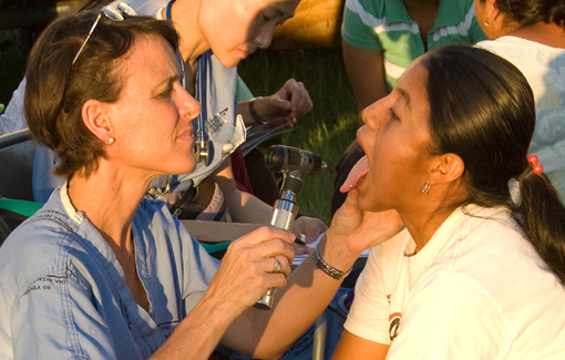 advanced nurse practitioner student examining a young woman