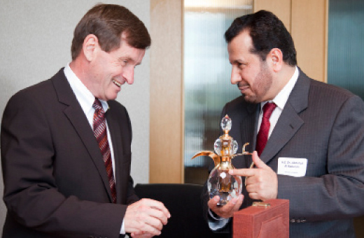 Dean James Curran accepts a gift from Saudi Minister of Health Abullah Al Rabeeah 
