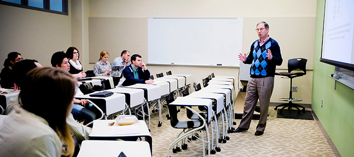 professor giving a lecture to students in a classroom